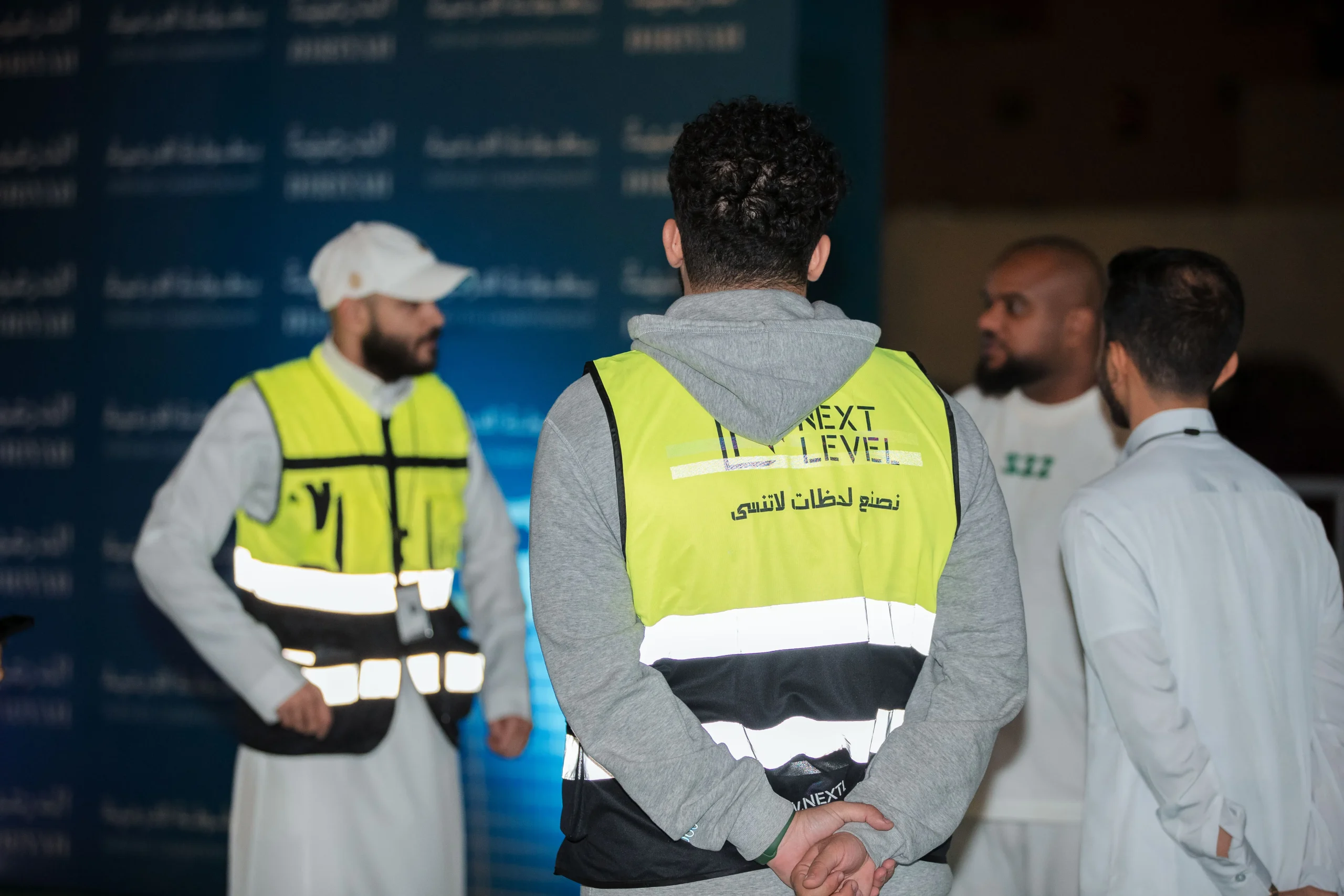 NEXT LEVEL crew in safety vests coordinating on site
